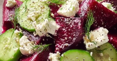 Colorful Beet Feta Salad with greens, feta cheese, and dressing