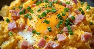 Cheesy potato egg scramble topped with herbs and cheese