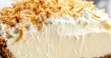 No Bake Coconut Cream Pie topped with whipped cream and toasted coconut flakes