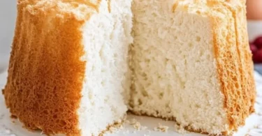 Old-Fashioned Angel Food Cake topped with fresh berries and whipped cream