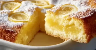 One-Bowl Lemon Cake with a lemon glaze on a wooden table