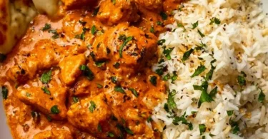 Delicious homemade butter chicken served with rice and naan bread