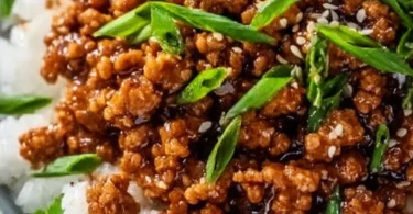 Delicious honey garlic ground turkey served on a plate with green garnish