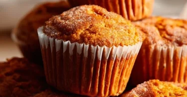 Freshly baked sweet potato muffins on a wooden table