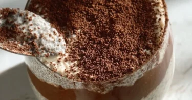 Viral tiramisu chia pudding in a glass topped with cocoa and coffee beans