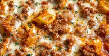 Delicious Beefy Tortellini Bake topped with cheese and herbs