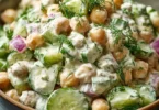 Chickpea and cucumber salad with creamy yogurt dressing served in a bowl
