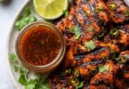 Homemade chili lime marinade in a glass bowl with fresh ingredients