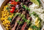 Cilantro lime steak bowls garnished with fresh cilantro and lime wedges