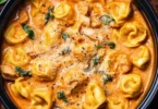 Delicious CrockPot Chicken Tortellini served in a bowl with herbs and vegetables