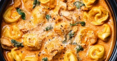 Delicious CrockPot Chicken Tortellini served in a bowl with herbs and vegetables