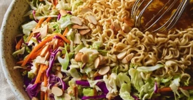 Crunchy ramen noodle salad with colorful vegetables and dressing