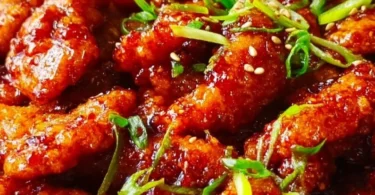 Plate of spicy Dragon Chicken with vibrant vegetables and rich sauce.