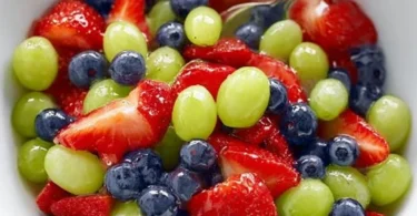 Honey lime fruit salad with mixed fresh fruits served in a bowl