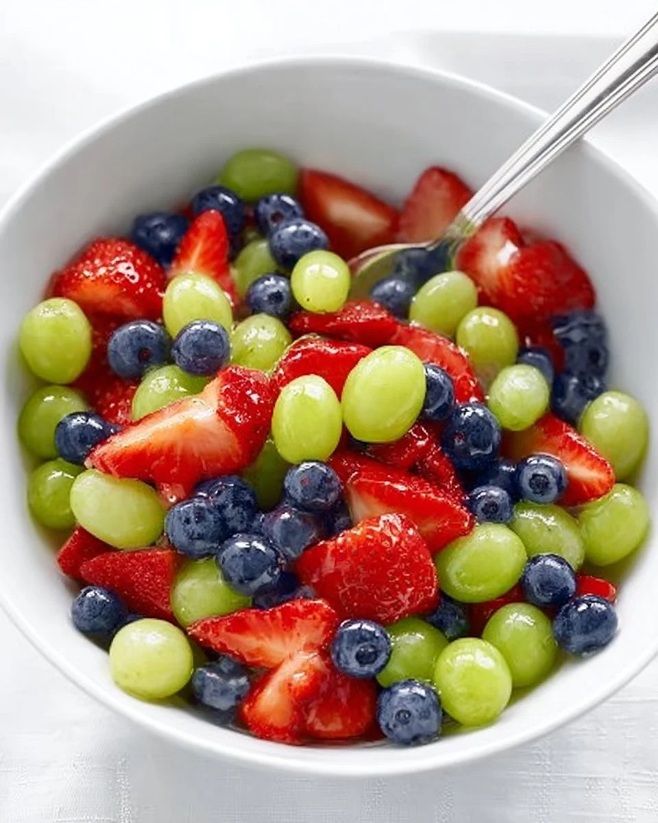 Honey lime fruit salad with mixed fresh fruits served in a bowl