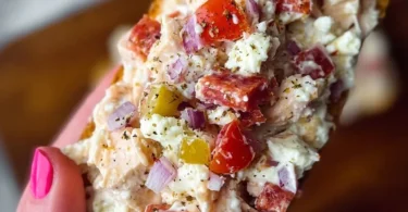 Bowl of Italian Grinder Chicken Salad with fresh vegetables and dressing