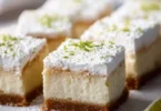 Delicious Key Lime Pie Bars topped with whipped cream and lime zest