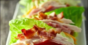 Low Carb Chicken Club Sandwich with crispy chicken, bacon, and fresh vegetables.