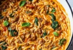 Quick ground beef orzo with tomato cream sauce served in a bowl