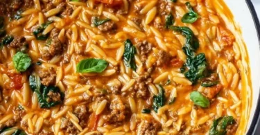 Quick ground beef orzo with tomato cream sauce served in a bowl