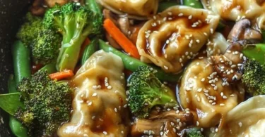 Bowl of quick potsticker stir fry with vegetables and sauce