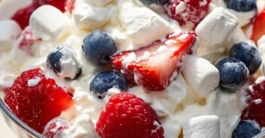 Delicious Red White and Blue Cheesecake Salad with fresh berries and creamy dressing.