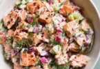 Colorful salmon salad with mixed greens and vibrant vegetables