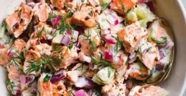 Colorful salmon salad with mixed greens and vibrant vegetables