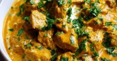 Slow Cooker Chicken Korma served with rice and fresh herbs