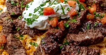 Delicious Steak Cheese Rice dish served in a bowl with melted cheese and steak.
